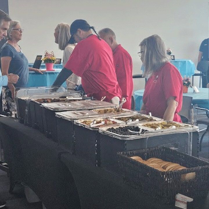 Guests moving through a Meat and Greet buffet line