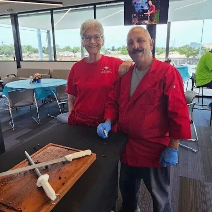 Jim Carroll in his red chef coat with Gemma at a Meat and Greet event